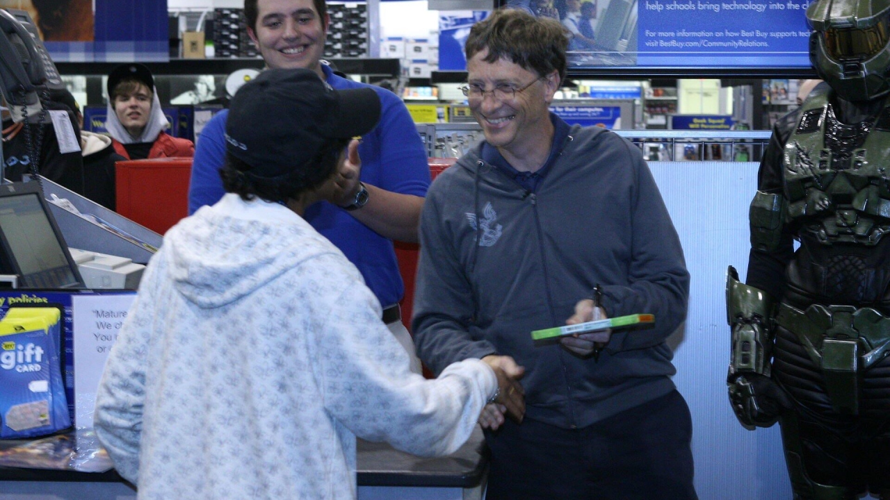 A picture of Bill Gates officially handing off the first officially sold copy of Halo 3.