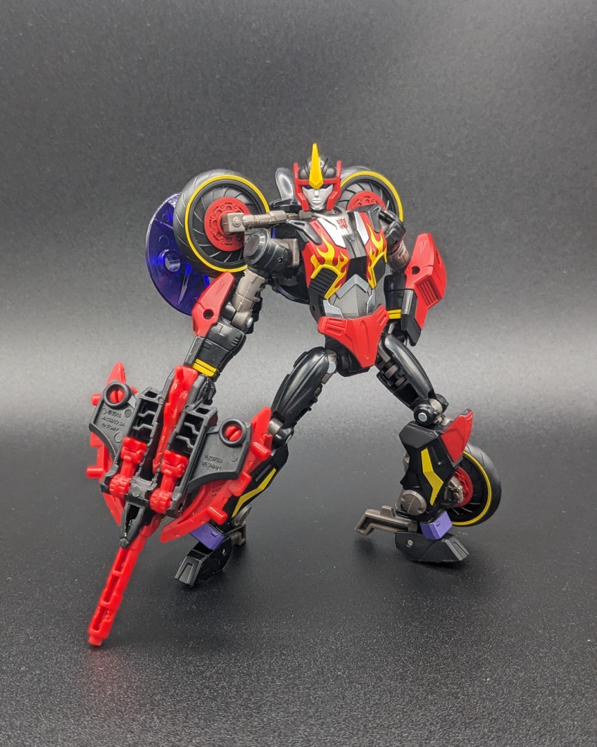 A picture of Flamewar in robot mode, wielding Fireglide in weapon mode.