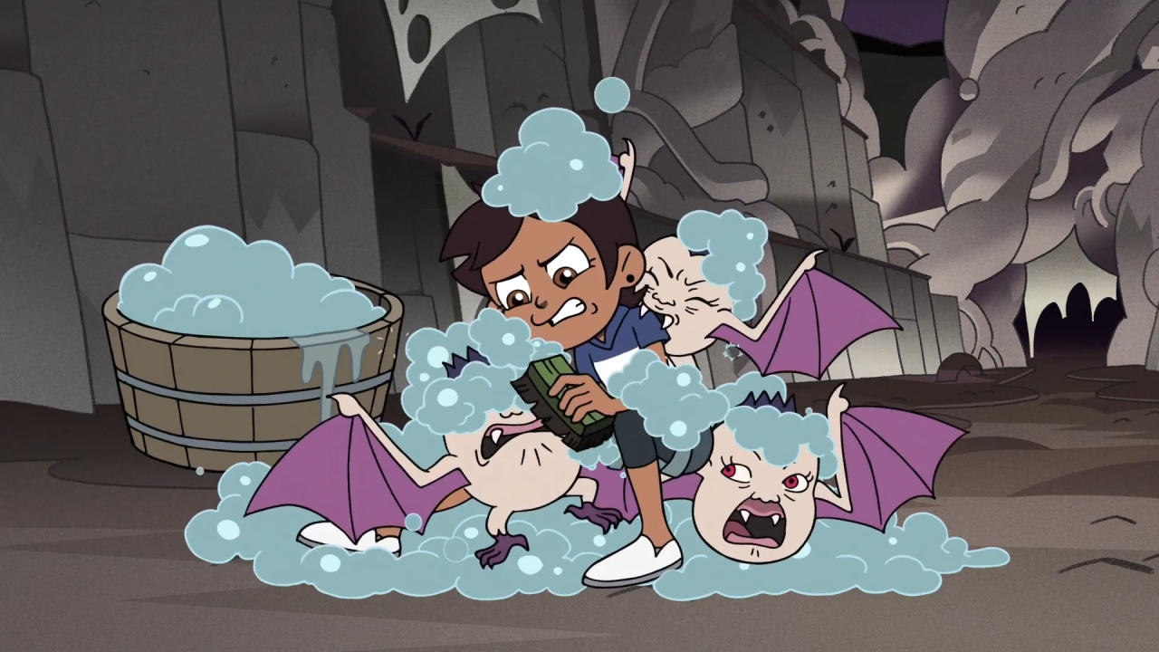 A screenshot from Escape of the Palisman, with Luz cleaning off the Bat Queen's babies.