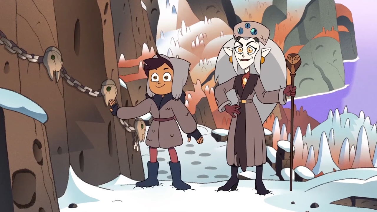 A screenshot from Adventures in the Elements, with Luz and Eda arriving at the Knee in winter attire.