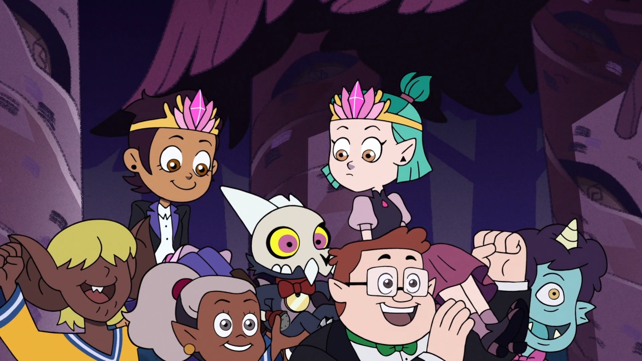 A screenshot from Enchanting Grom Fright, with the crowd lifting up Luz, Amity, and King after defeating Grometheus.