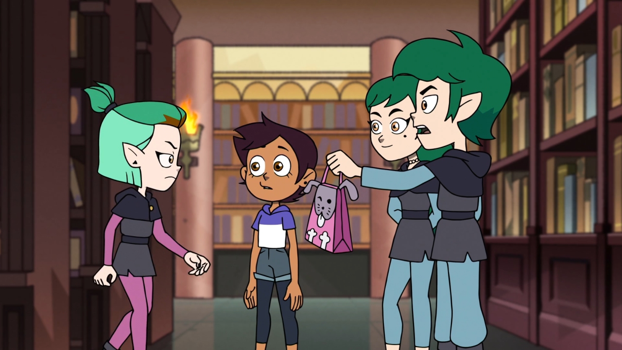 A screenshot from Lost in Language, with Edric and Emira handing Amity her lunch.